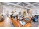 Spacious living room with hardwood floors, coffered ceiling, and views of kitchen and staircase at 668 Ferry St, Mount Pleasant, SC 29464