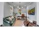 Stylish home office with a green couch, tufted brown leather ottoman, and an ornate desk at 668 Ferry St, Mount Pleasant, SC 29464