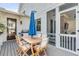 Outdoor dining area with a table, umbrella, chairs, and a grill at 668 Ferry St, Mount Pleasant, SC 29464