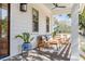 Inviting covered porch with wicker furniture and ceiling fan offers a relaxing outdoor space at 668 Ferry St, Mount Pleasant, SC 29464