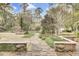 Stone path in a landscaped yard leading to a verdant garden at 710 S Main St, Summerville, SC 29483
