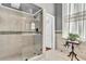 Modern bathroom with a glass-enclosed shower, tiled walls, and decorative accents at 710 S Main St, Summerville, SC 29483