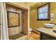 Bathroom featuring stone tiled shower, granite counter vanity, and large window for natural lighting at 710 S Main St, Summerville, SC 29483