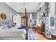 A gorgeous bedroom features a four-poster bed, hardwood floors, and a chandelier at 710 S Main St, Summerville, SC 29483