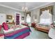 Bright bedroom with two beds features a vintage-style decor and access to a sitting room at 710 S Main St, Summerville, SC 29483