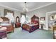 Cozy bedroom features decorative chandelier, quaint details, and comfortable beds at 710 S Main St, Summerville, SC 29483