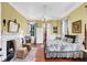 Well-lit bedroom features a fireplace, desk, four poster bed and hardwood floors at 710 S Main St, Summerville, SC 29483