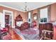 Charming bedroom with hardwood floors, floral curtains, and decorative antique furniture at 710 S Main St, Summerville, SC 29483