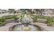 Picturesque water fountain surrounded by lush greenery, flowers, benches, and walking paths at 710 S Main St, Summerville, SC 29483