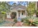 Quaint exterior featuring a charming porch, brick walkway, and flowering shrubs at 710 S Main St, Summerville, SC 29483
