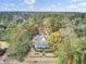Stately two-story home with large porch nestled among lush trees and mature landscaping at 710 S Main St, Summerville, SC 29483