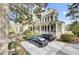 Two-story home with a large porch, black shutters, and driveway featuring two parked cars at 710 S Main St, Summerville, SC 29483