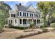 Elegant home boasting a grand front porch, complemented by a lush landscaped yard and a classic architectural design at 710 S Main St, Summerville, SC 29483