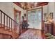 Elegant foyer with wooden staircase, a chandelier, and a decorative rug creating a classic entrance at 710 S Main St, Summerville, SC 29483