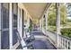 Relaxing front porch with rocking chairs, patterned rug, and columns providing a cozy outdoor space at 710 S Main St, Summerville, SC 29483