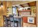 Rustic kitchen featuring bar seating, wood beam accents, and unique tile backsplash details at 710 S Main St, Summerville, SC 29483