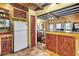 Bright kitchen showcasing custom red cabinetry, granite countertops, and view to the bedroom at 710 S Main St, Summerville, SC 29483