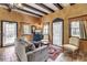 Cozy living room with wooden beam ceilings, comfortable seating, and plenty of natural light at 710 S Main St, Summerville, SC 29483