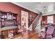 Elegant living room with detailed wood trim, a vintage organ, and access to a staircase at 710 S Main St, Summerville, SC 29483