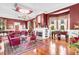 Elegant living room with hardwood floors, a fireplace, chandelier, and large windows at 710 S Main St, Summerville, SC 29483