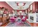 Elegant living room featuring a fireplace, chandelier, and a decorative rug at 710 S Main St, Summerville, SC 29483