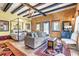 Tastefully decorated bedroom with a canopy bed, comfortable seating, and rustic wooden beam accents at 710 S Main St, Summerville, SC 29483