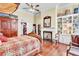 Bright main bedroom with a fireplace, built-in shelves, and a decorative quilt on the bed at 710 S Main St, Summerville, SC 29483