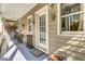 Inviting porch with seating and decorative accents, featuring a welcome mat by the front door at 710 S Main St, Summerville, SC 29483