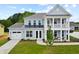 Charming two-story home with light blue siding, a covered porch and an attached garage at 742 Maynard Ln, Summerville, SC 29486