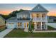 Charming two-story home with light blue siding, a covered porch and manicured lawn at 742 Maynard Ln, Summerville, SC 29486