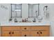 Double vanity bathroom with modern fixtures, wood cabinets, and decorative mirrors at 743 Redbud Ln, Summerville, SC 29486