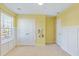 Light-filled bedroom with yellow walls, wainscoting, and a double door closet at 743 Redbud Ln, Summerville, SC 29486