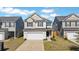 Two-story home with neutral siding, black shutters, and an attached two-car garage at 743 Redbud Ln, Summerville, SC 29486
