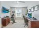 Bright home office with ceiling fan, large window, exercise bike, and a spacious wooden desk for productivity at 743 Redbud Ln, Summerville, SC 29486
