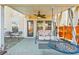 Covered patio with ceiling fan, swing, comfortable seating, and outdoor dining area at 743 Redbud Ln, Summerville, SC 29486