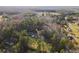 Aerial view of property surrounded by lush green trees and autumn foliage, set against a clear blue sky at 754 Miriam Ln, Ridgeville, SC 29472