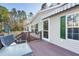 Home's back deck features wood railings, outdoor seating, and an awning for shade at 754 Miriam Ln, Ridgeville, SC 29472