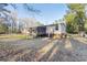 Exterior view of home featuring a screened in porch and grassy backyard at 754 Miriam Ln, Ridgeville, SC 29472