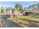 Backyard with a screened in porch and brick underpinning at 754 Miriam Ln, Ridgeville, SC 29472
