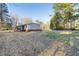 A view of the side and back of the home with a wooded backdrop at 754 Miriam Ln, Ridgeville, SC 29472