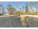 Large, grassy backyard with outbuilding and wooded tree line at 754 Miriam Ln, Ridgeville, SC 29472