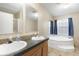 Bathroom with double sinks, spacious vanity, a soaking tub and plenty of natural light at 754 Miriam Ln, Ridgeville, SC 29472
