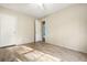 Light-filled bedroom with wood-look flooring, two closet doors, and an open doorway that leads to another space at 754 Miriam Ln, Ridgeville, SC 29472