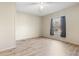 Bright, empty bedroom with wood-look flooring, a neutral color scheme, and a window letting in natural light at 754 Miriam Ln, Ridgeville, SC 29472