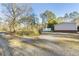 Side view of home with gravel driveway and additional storage on property at 754 Miriam Ln, Ridgeville, SC 29472
