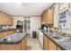 Well-lit kitchen featuring wood cabinets, an island, and modern appliances for easy meal prep at 754 Miriam Ln, Ridgeville, SC 29472