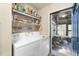 Bright laundry room with white washer and dryer and access to screened porch at 754 Miriam Ln, Ridgeville, SC 29472