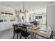 Elegant dining area with a wooden table, chandelier, and seamless transition to the kitchen, perfect for entertaining at 758 Blueway Ave, Summerville, SC 29486