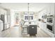 Well-lit kitchen with stainless steel appliances, white cabinets, a center island, and access to the backyard at 758 Blueway Ave, Summerville, SC 29486