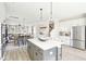 Open-concept kitchen with white cabinets, stainless steel appliances, and a center island with a clear view into living areas at 758 Blueway Ave, Summerville, SC 29486